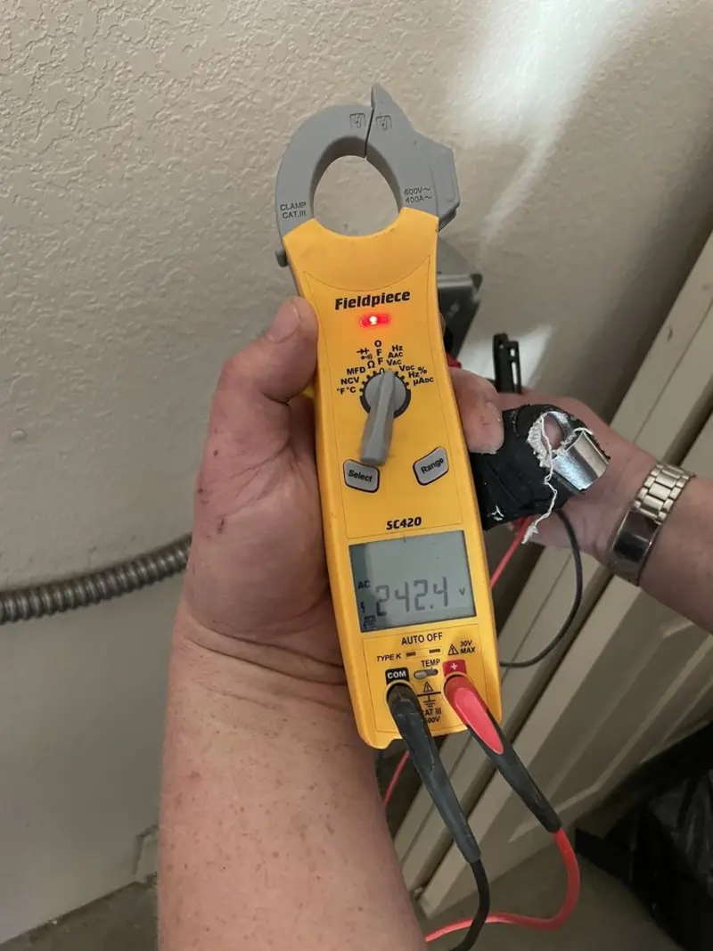 Voltage testing with clamp meter during Outlet Installation in Papillion